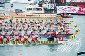 Dragon boat teams, with hard thrashing paddles, are racing neck and neck.