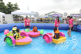 Kids are enjoying with hand-powered paddle boats.