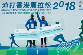 Champions of the Men's and the Women's Marathons pose for a photo together with their prize cheques.