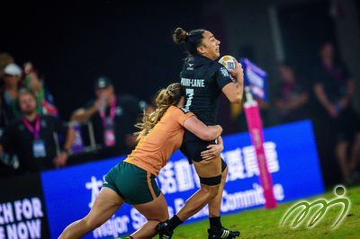 An Australian defender tries to force back a New Zealander with the ball in Sunday's Women's Cup Final