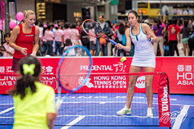 Angelique KERBER (left) from Germany and Christina McHALE (right) from the U.S. 'warm up' with the public before the competition on a mini-tennis court on Chater Road in Central.