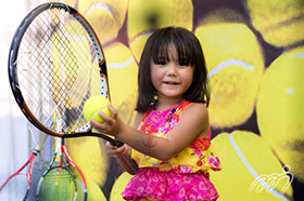 A little girl wears a happy smile after the speed gun game in the Tournament Village.