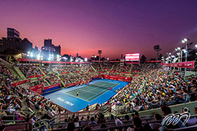 Victoria Park Tennis Stadium at sunset, crowded with an audience of over 3 000.