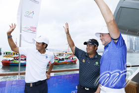 Taichi Kho (Hong Kong), Kiradech Aphibarnrat (Thailand) and Ian Poulter (England) wave during a media event prior to the start of the World City Championship.