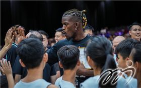 Jimmy Butler is interacting with the local players and young players.